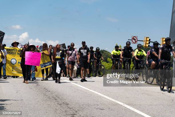 Police on bicycles block off road ways for protestors as they march and chant in Downtown Atlanta, in opposition to Georgia's new abortion law on...