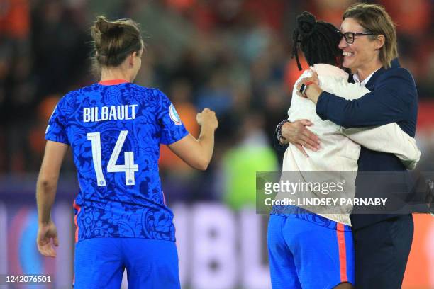 France's head coach Corinne Diacre and players celebrate their victory at the end of the UEFA Women's Euro 2022 quarter final football match between...
