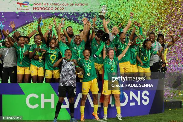 South africa's players lift the trophy as they celebrate winning the 2022 Women's Africa Cup of Nations final football match between Morocco and...