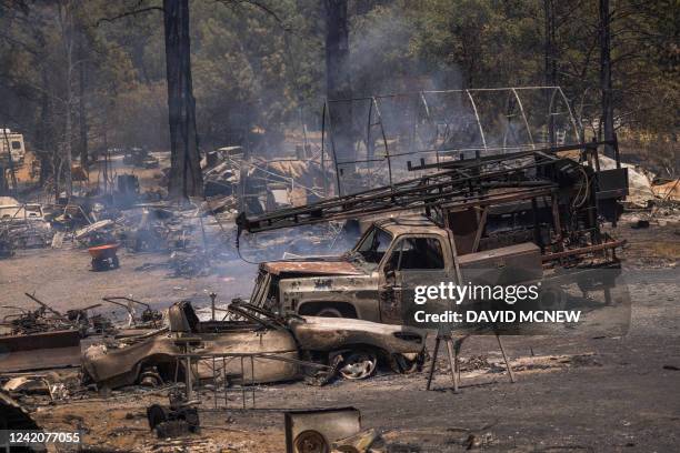 Destroyed property is left in its wake as the Oak Fire chews through the forest near Midpines, northeast of Mariposa, California, on July 23, 2022....