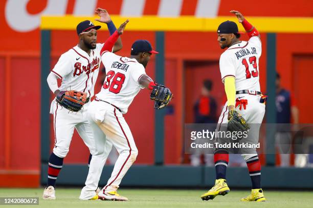Michael Harris II, Guillermo Heredia and Ronald Acuna Jr. #13 of the Atlanta Braves react after the 7-2 victory over the Los Angeles Angels at Truist...