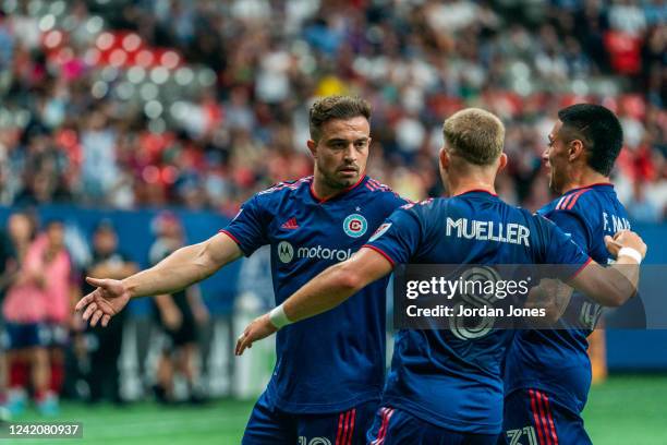 Xherdan Shaqiri of the Chicago Fire FC celebrates with his teammate Chris Mueller after scoring against Vancouver Whitecaps FC at BC Place on July...