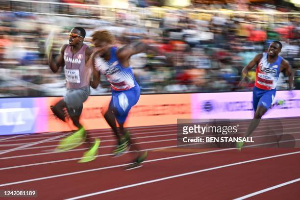 Canada's Aaron Brown runs beside USA's Noah Lyles after he received the baton from USA's Christian Coleman in the men's 4x100m relay final during the...