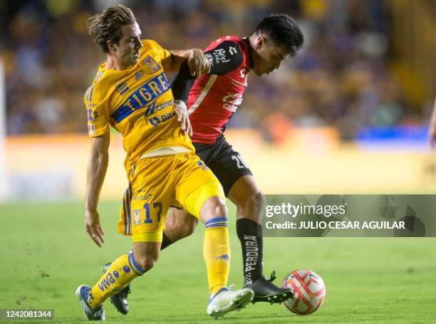Francisco Cordova of Tigres vies for the ball with Aldo Rocha of Atlas during the Mexican Clausura 2022 football tournament match at the...