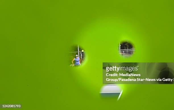 View through a pickleball during a match at the Arroyo Seco Racquet Club in South Pasadena on Saturday, July 23, 2022.