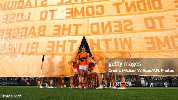 Braydon Preuss of the Giants runs thru the banner during the 2022 AFL Round 19 match between the Carlton Blues and the GWS Giants at Marvel Stadium...