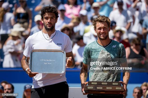 Norway's Casper Ruud poses next to Italy's Matteo Berrettini with the trophy after winning his final match at the Swiss Open tennis tournament in...