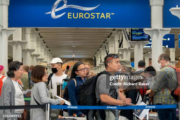 Eurostar passengers and holidaymakers queue to access French border controls on the British side at start of the summer holiday weekend which has led...