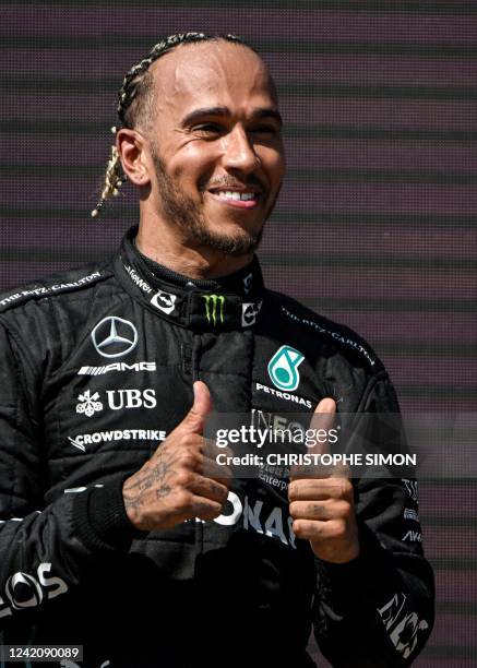 Second placed Mercedes' British driver Lewis Hamilton celebrates on the podium of the French Formula One Grand Prix at the Circuit Paul-Ricard in Le...