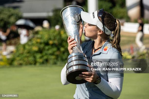Brooke Henderson of Canada celebrates with the trophy after winning the Evian Championship in the French Alps town of Evian-les-Bains, a major...