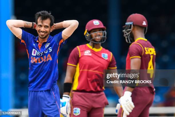 Yuzvendra Chahal of India smiles after Nicholas Pooran of West Indies hits him for 6 during the 2nd ODI match between West Indies and India at Queens...