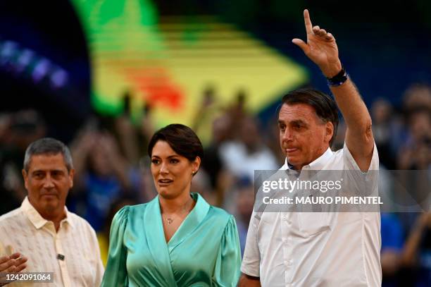 Brazil's President Jair Bolsonaro gestures next to his wife Michelle Bolsonaro during the Liberal Party national convention where he was officially...