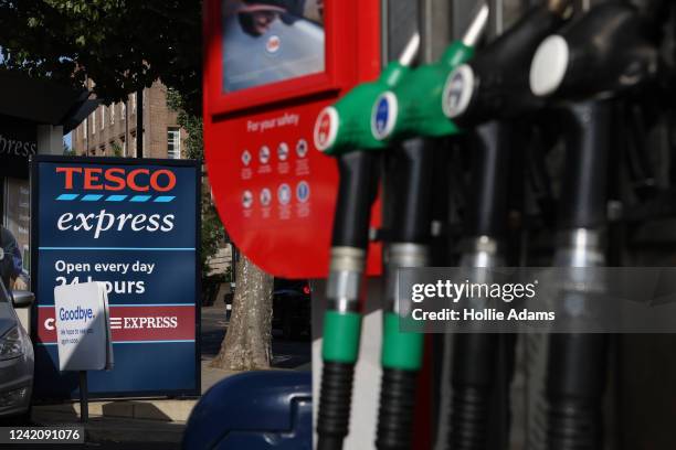 Fuel pumps at an Esso Tesco petrol station on July 24, 2022 in London, England. Many Supermarket Fuel Stations are still charging high prices on the...