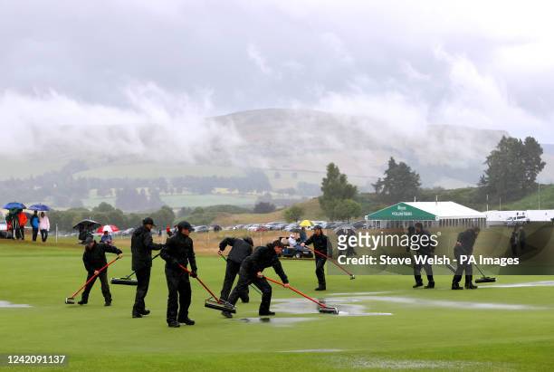Ground staff work to clear water off of the course after heavy rain disrupts play on day four of the Senior Open at PGA Centenary Course, Gleneagles....