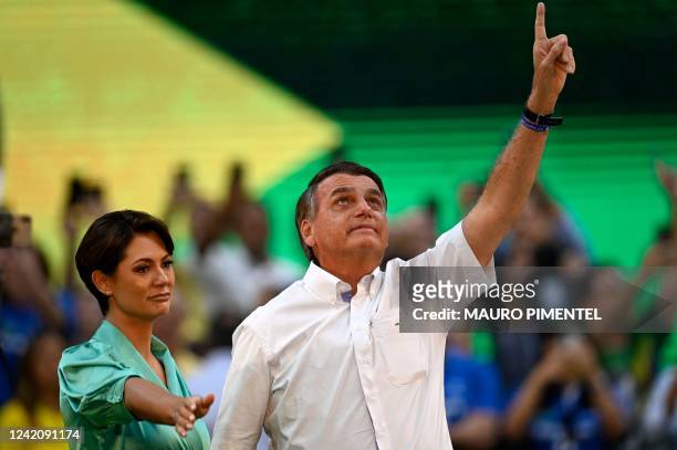Brazils President Jair Bolsonaro gestures next to his wife Michelle Bolsonaro during the Liberal Party national convention where he was officially...