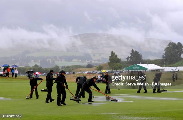 Ground staff work to clear water off of the course after heavy rain disrupts play on day four of the Senior Open at PGA Centenary Course, Gleneagles....