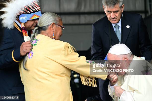 Pope Francis greets members of an indigenous tribe during his welcoming ceremony at Edmonton International Airport in Alberta, western Canada, on...