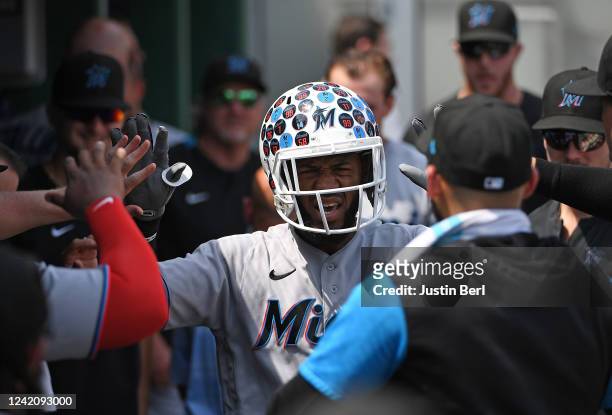 Bryan De La Cruz of the Miami Marlins celebrates with teammates in the dugout after hitting a solo home run in the fifth inning during the game...
