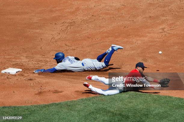 George Springer of the Toronto Blue Jays safely steals second base as the throw gets by Yolmer Sanchez of the Boston Red Sox during the second inning...