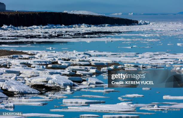 Icebergs float in Baffin Bay in the Arctic Ocean on July 18, 2022 near Pituffik, Greenland as captured from the ground on a NASA mission along with...