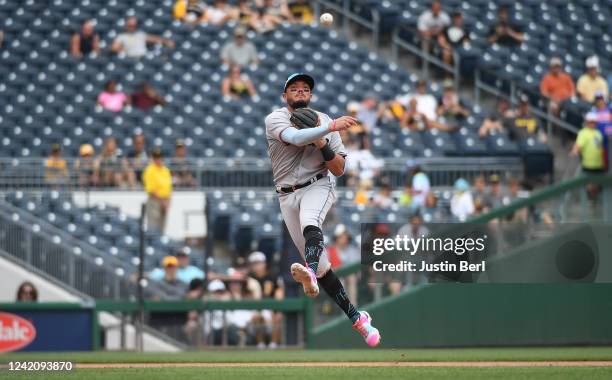 Miguel Rojas of the Miami Marlins throws to first base to force out Yoshi Tsutsugo of the Pittsburgh Pirates in the seventh inning during the game at...