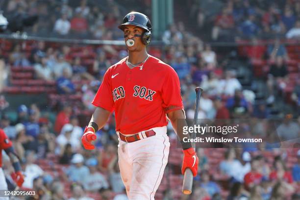 Jeter Downs of the Boston Red Sox pops a bubble on his way back to the dugout after striking out during the ninth inning against the Toronto Blue...