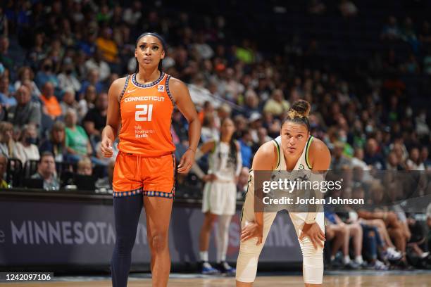 DiJonai Carrington of the Connecticut Sun and Kayla McBride of the Minnesota Lynx look on during the gameon July 24, 2022 at Target Center in...