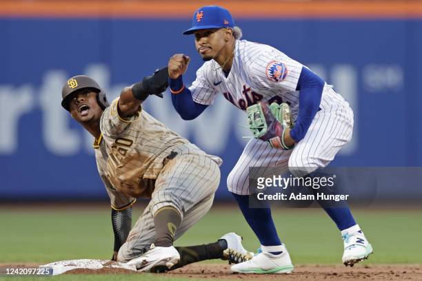 Francisco Lindor of the New York Mets pumps his fist after tagging out Esteury Ruiz of the San Diego Padres on a steal attempt in the second inning...