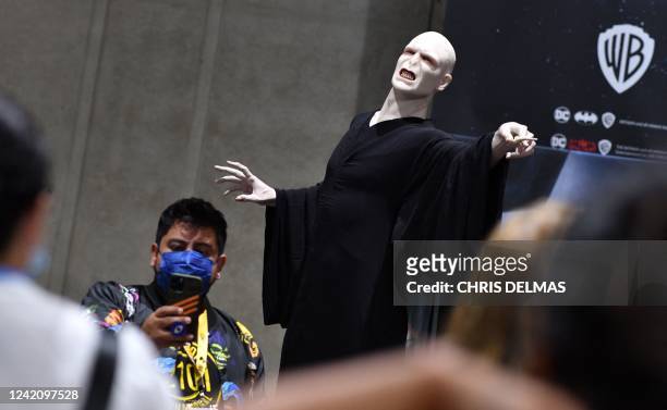 Attendees walk by a statue of Lord Voldemort from the "Harry Potter" book and film series during San Diego Comic-Con International in San Diego,...
