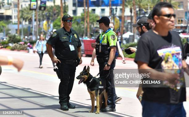 Police officers from the K-9 unit patrol in front of the convention center during San Diego Comic-Con International in San Diego, California, on July...