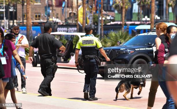 Police officers from the K-9 unit patrol in front of the convention center during San Diego Comic-Con International in San Diego, California, on July...