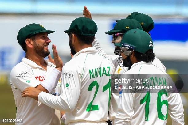 Pakistan's Yasir Shah celebrates with teammates after taking the wicket of Sri Lanka's Prabath Jayasuriya during the second day of the second cricket...