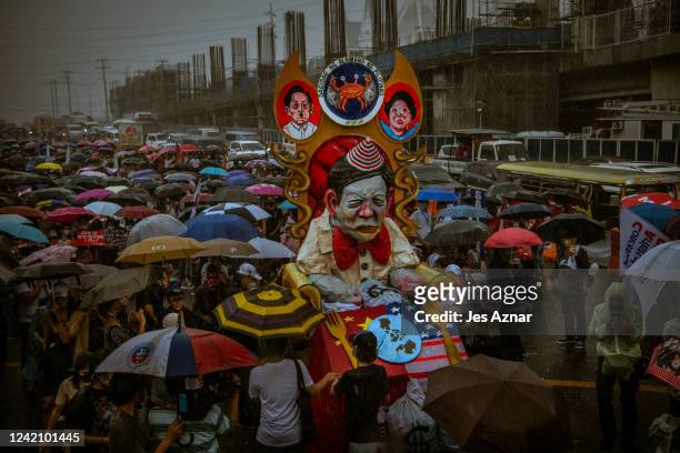 An effigy mocking Philippines president Ferdinand Marcos Jr. Is paraded on the streets as Filipinos march to protest his first state of the nation...