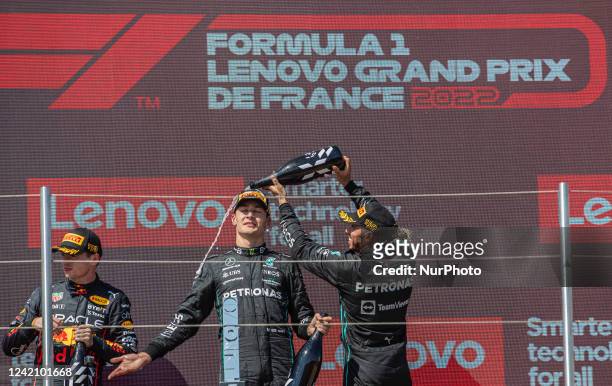 Lewis Hamilton of Great Britain and Mercedes AMG Petronas driver splash on the podium at French Lenovo Formula 1 Grand Prix on July 24, 2022 in Le...