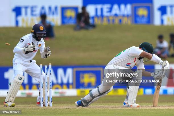 Pakistan's Imam-ul-Haq is clean bowled as Sri Lanka's wicketkeeper Niroshan Dickwella watches during the second day of the second cricket Test match...