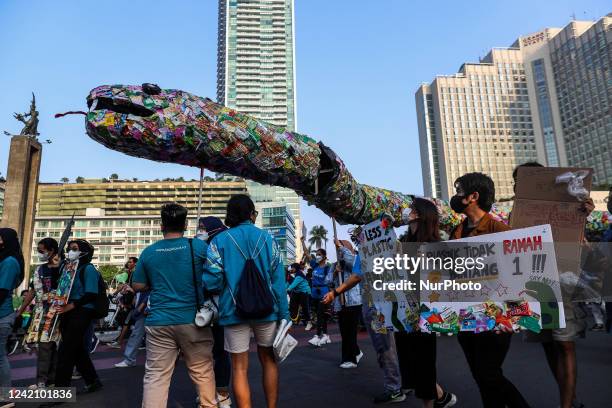 Activists take part in a rally pushing for rejecting single-use plastic products in Jakarta, Indonesia on July 24, 2022. During the parade, the...