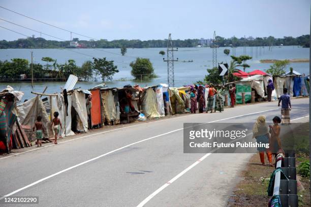 Flood-affected residents have taken shelter by building temporary huts on the roadside. On July 22, 2022 in Sylhet, Bangladesh.