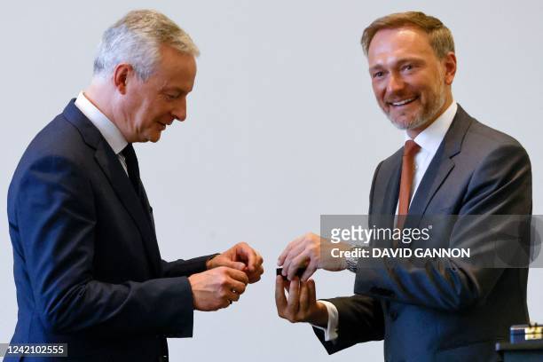 German Finance Minister Christian Lindner awards France's Finance Minister Bruno Le Maire with the Great Cross of Merit with Star and Sash of the...