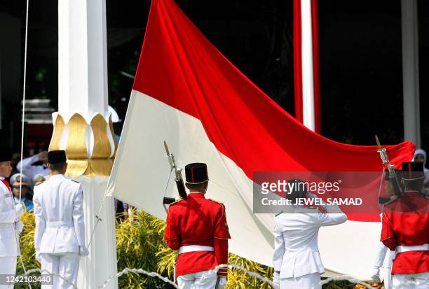 Indonesian soldiers hoist the national flag during a ceremony to celebrate the country's 62th Independence Day anniversary at the Presidential Palace...
