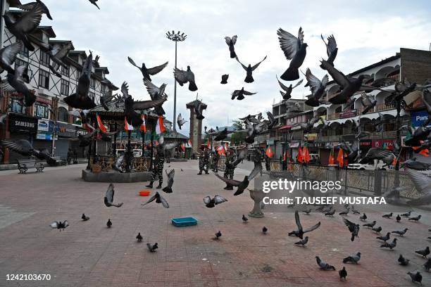 Indian paramilitary troopers patrol during the Bharatiya Janata Party's Tiranga bikers rally at the clock tower in Lal Chowk area of Srinagar on July...