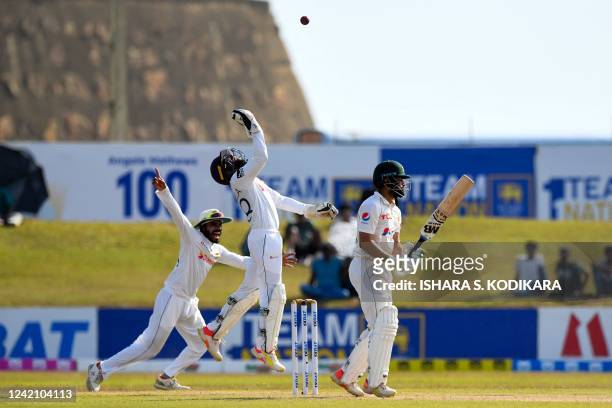 Sri Lanka's wicketkeeper Niroshan Dickwella and teammate Dhananjaya de Silva celebrate after the dismissal of Pakistan's Mohammad Nawaz during the...