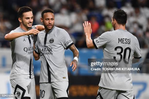 Paris Saint-Germain's Spanish midfielder Pablo Sarabia celebrates his goal with teammates Brazilian forward Neymar and Argentinian forward Lionel...