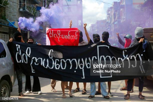 Young demonstrators hold a large banner reading &quot;We Will Never Be Frightened&quot; during an anti-coup protest in Yangon, Myanmar on July 25,...