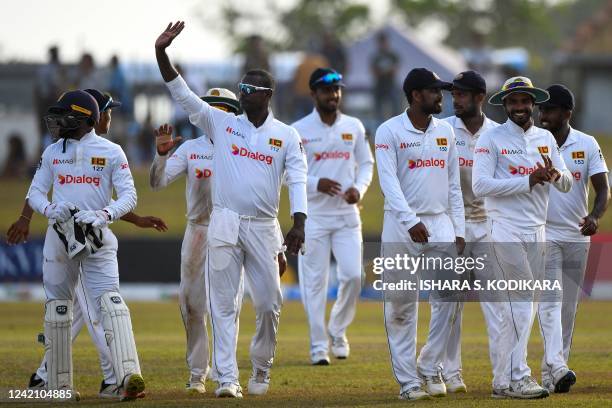 Sri Lanka's players walk back to the pavilion at the end of the second day play of the second cricket Test match between Sri Lanka and Pakistan at...