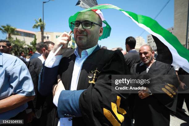 Palestinian lawyers, holding banners and Palestinian flags, protest the legislative decrees issued by Palestinian President Mahmoud Abbas in front of...