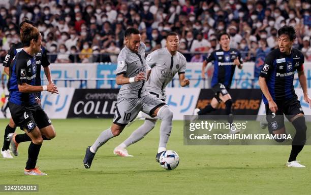 Paris Saint-Germain's Brazilian forward Neymar dribbles the ball past forward Kylian Mbappe during a friendly match against Gamba Osaka in PSG's...