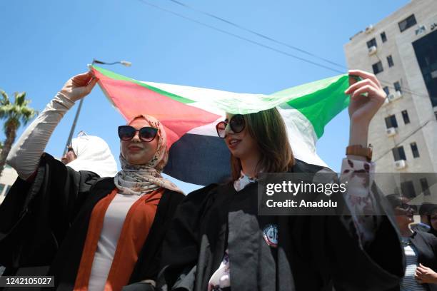 Palestinian lawyers, holding banners and Palestinian flags, protest the legislative decrees issued by Palestinian President Mahmoud Abbas in front of...