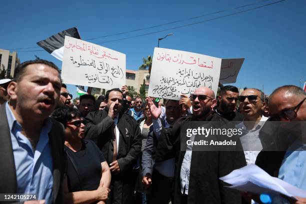 Palestinian lawyers, holding banners and Palestinian flags, protest the legislative decrees issued by Palestinian President Mahmoud Abbas in front of...