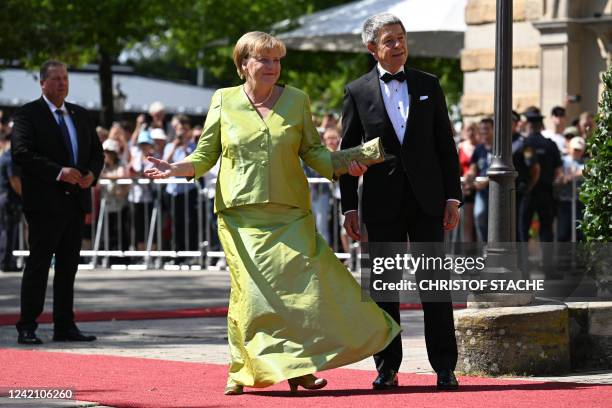 Former German chancellor Angela Merkel arrives with husband Joachim Sauer for the opening of the annual Bayreuth Festival featuring the music of...