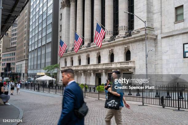 People walk outside of the New York Stock Exchange on July 25, 2022 in New York City. Stocks rose slightly in morning trading as investors weigh the...